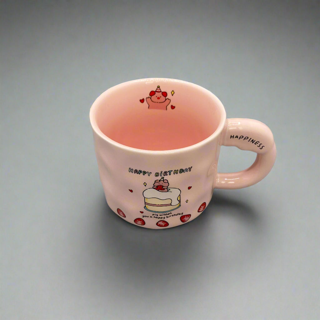 Pink mug with cartoon designs on a gray background