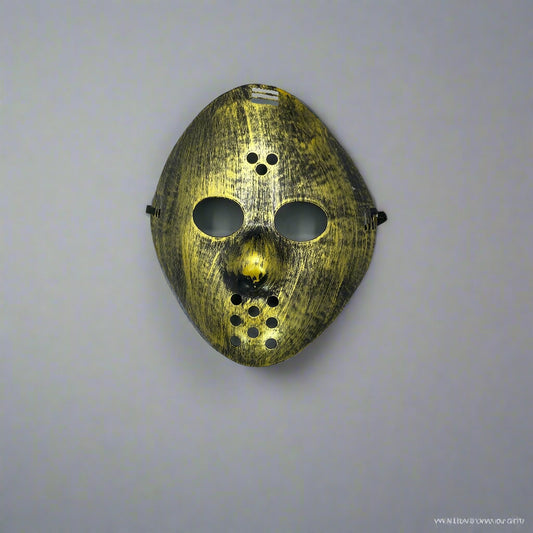 Decorative mask with gold and black design on a white background