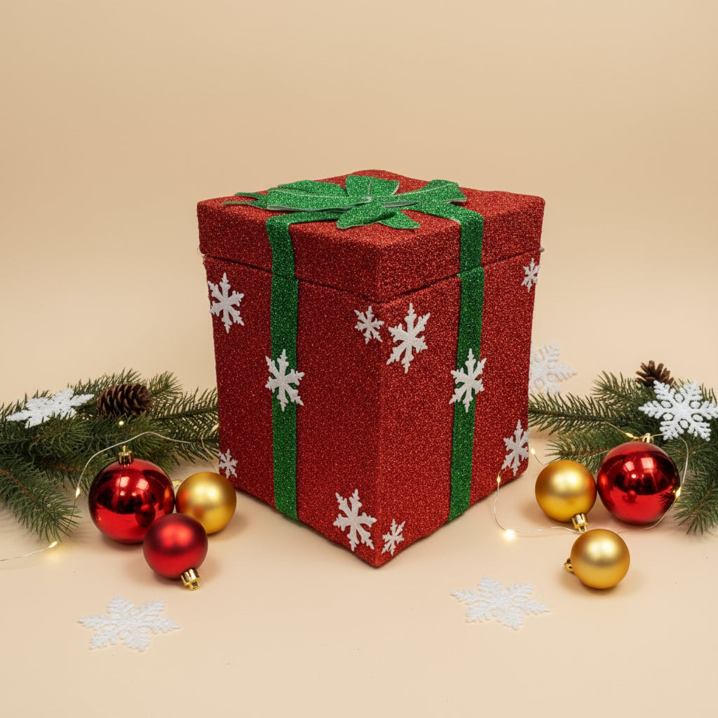Red glittery gift box with green bow and white snowflakes on a gray background
