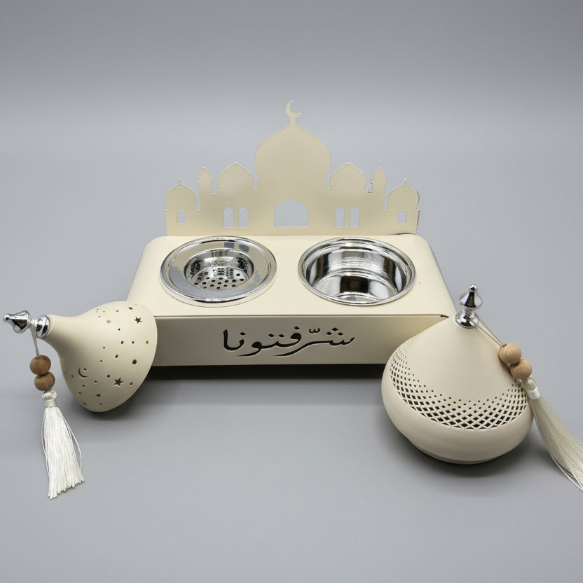 Decorative wall-mounted fixture with intricate designs on a gray wall.