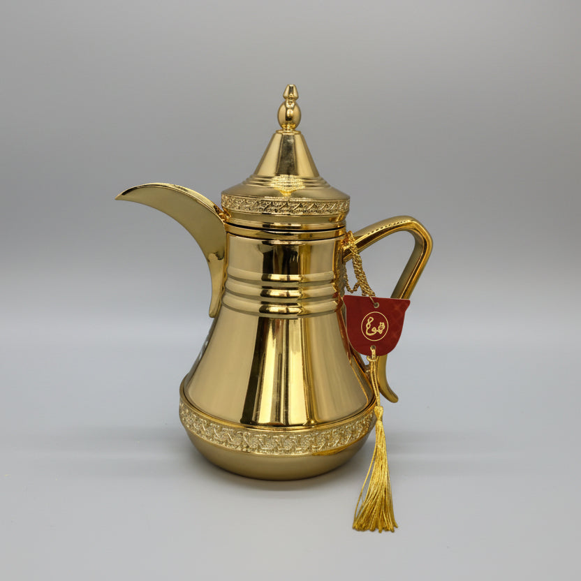 Gold-colored traditional container with a decorative tag on a gray background