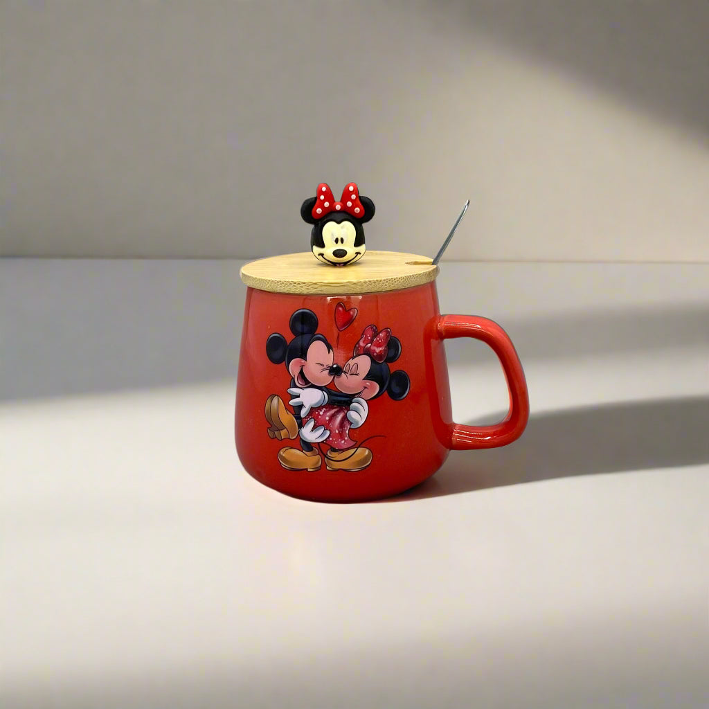 Red teapot-shaped container with cartoon character design on a gray wall.
