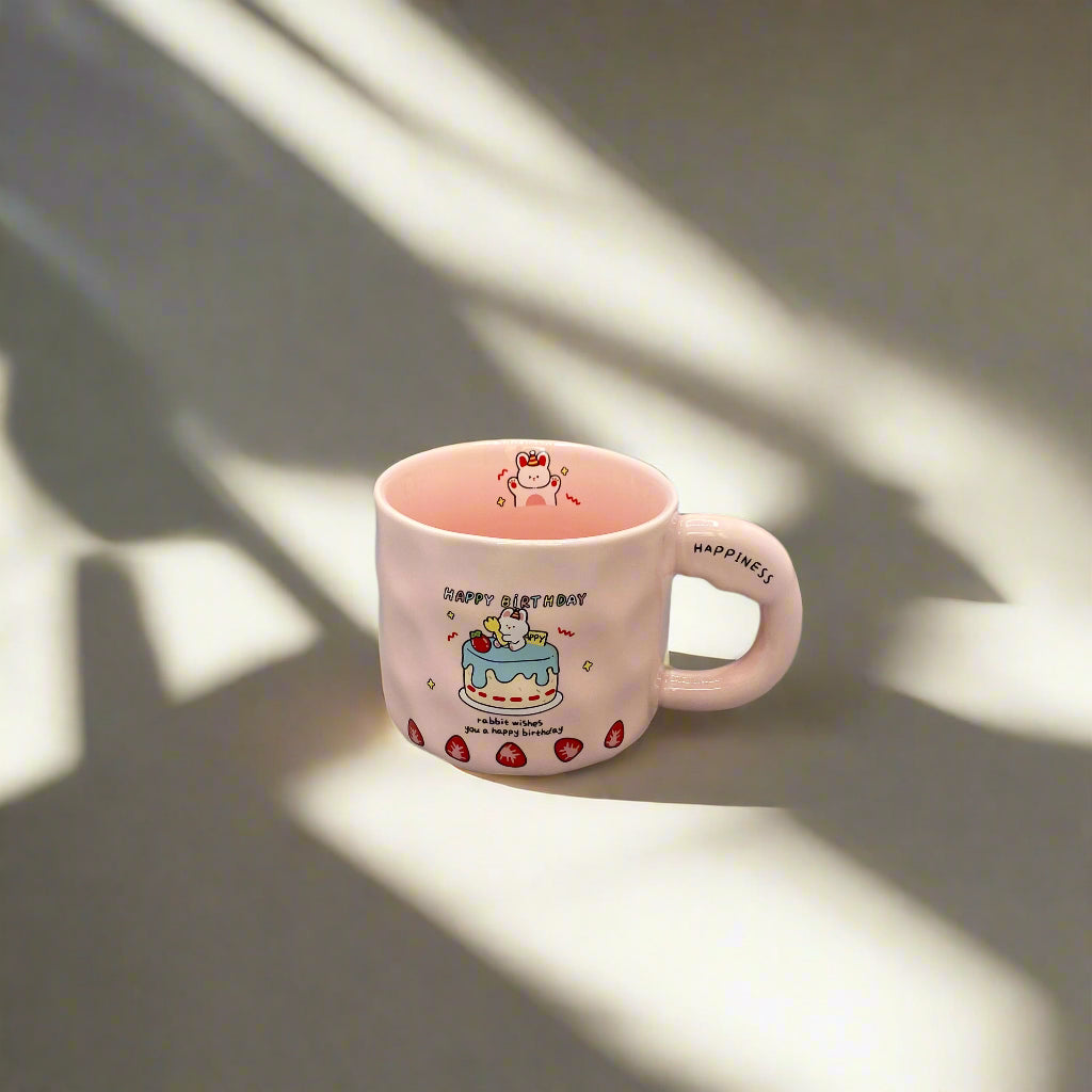 Pink mug with cartoon design on a gray background