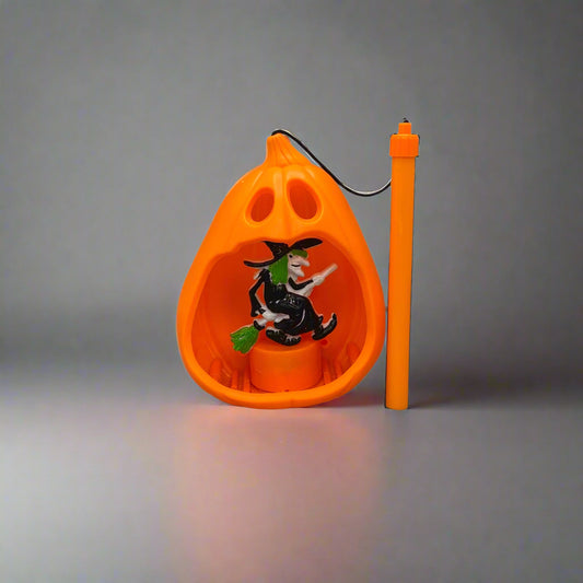 Orange wall-mounted pet toy with a black and white cat figure on a gray wall.
