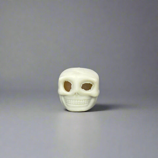 White skull-shaped object on a gray background
