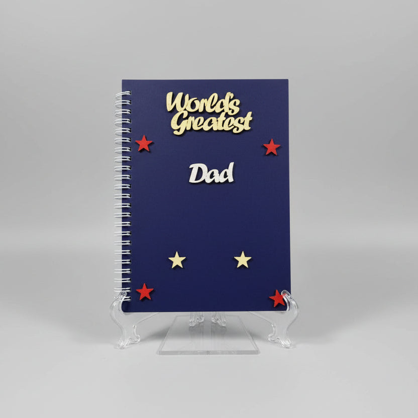 Notebook with 'World's Greatest Dad' text on a gray background
