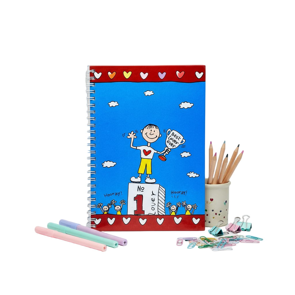 Notebook with colorful cover featuring a cartoon character, surrounded by pencils and stationery on a white background