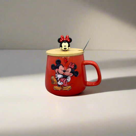 Red teapot-shaped container with cartoon character design on a gray wall.
