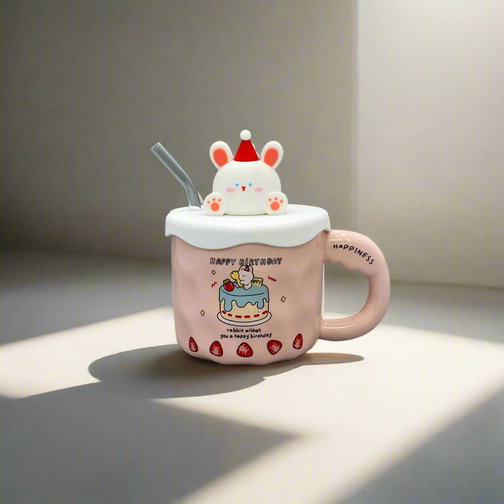 Pink cartoon-style mug with a lid and straw on a gray surface