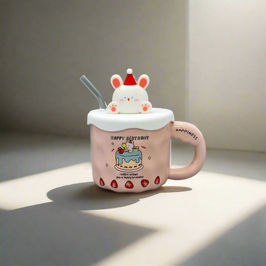 Pink cartoon-style mug with a lid and straw on a gray surface